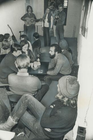 Coffee house crowd at the restyled Yonge Street Mission listen to music by The Sky -- Enzo Ianarelli, left, Ann Benson and Paul Snelgrove. Volunteer w(...)