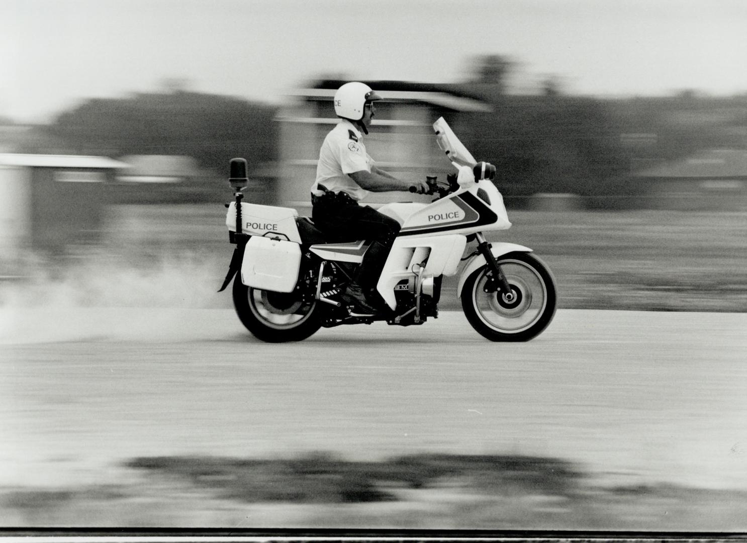 Busting skids: Constable Terry Browne of 14 Division practises emergency braking in grvel on one of the force's new BMW motorbikes equipped with ABS