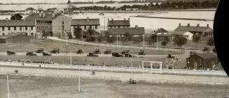 An unfamiliar view of Stanley Barracks, a waterfront and the Island, from the roof of the grandstand, Exhibition park, Toronto