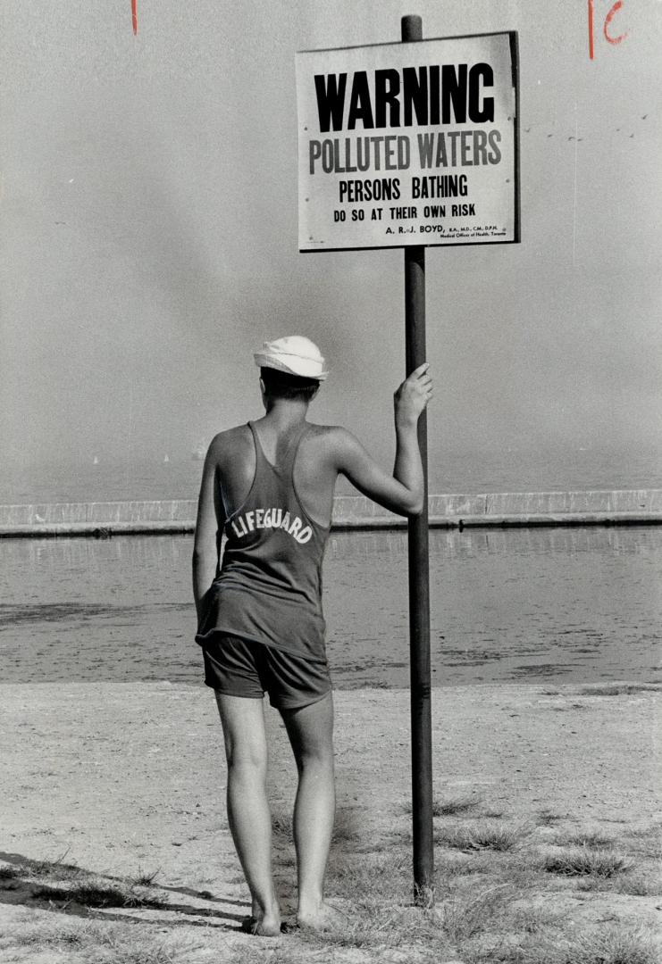 What's he guarding? Taking no chances: City of Toronto, which bans holiday swimming at Gzowski Park because of pollution, also takes the precaution of providing this lifequard