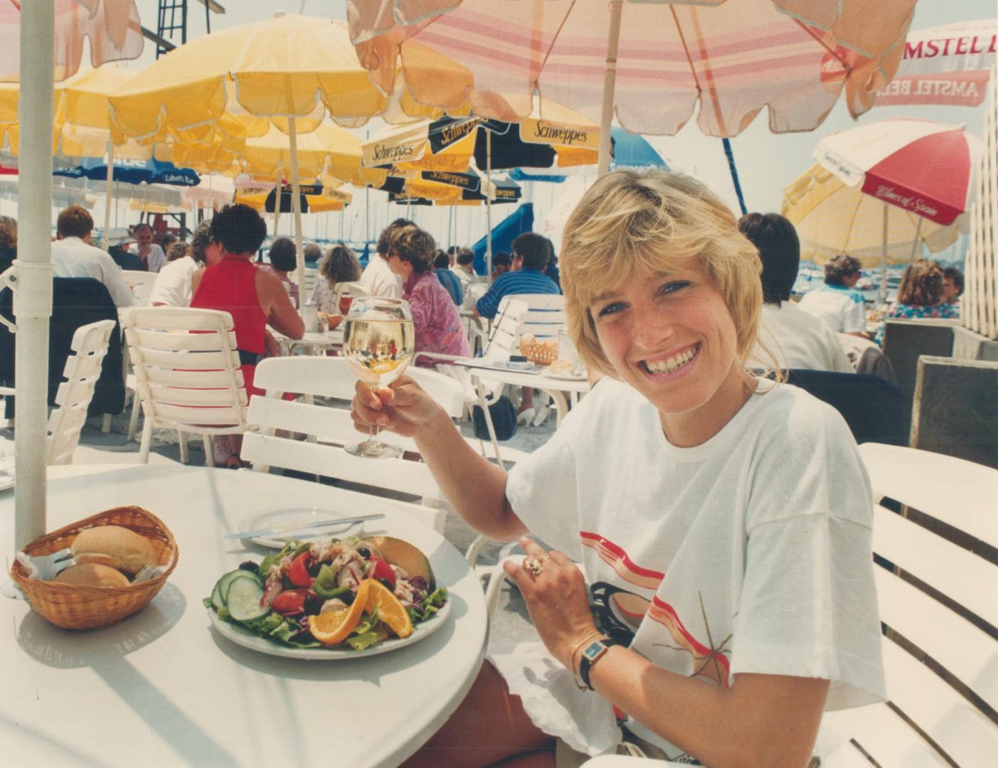 Kim Van Maren happily hoists a glass at Sgana Landing, in the best Toronto alfresco tradition