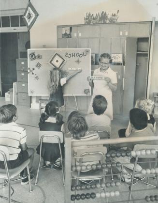 Mrs. Martha Norton goes through a lesson with youngsters in a rehabilitation class at West Preparatory School on Ridge Hill Dr. in Toronto. In the acc(...)