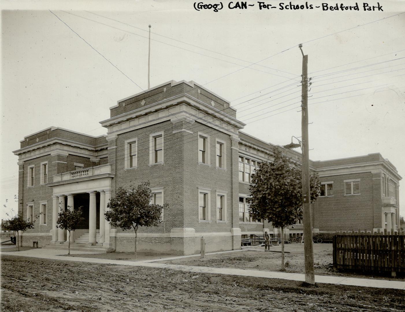 Original Toronto Star caption: Bedford park school. Image shows a two storey school with a few …