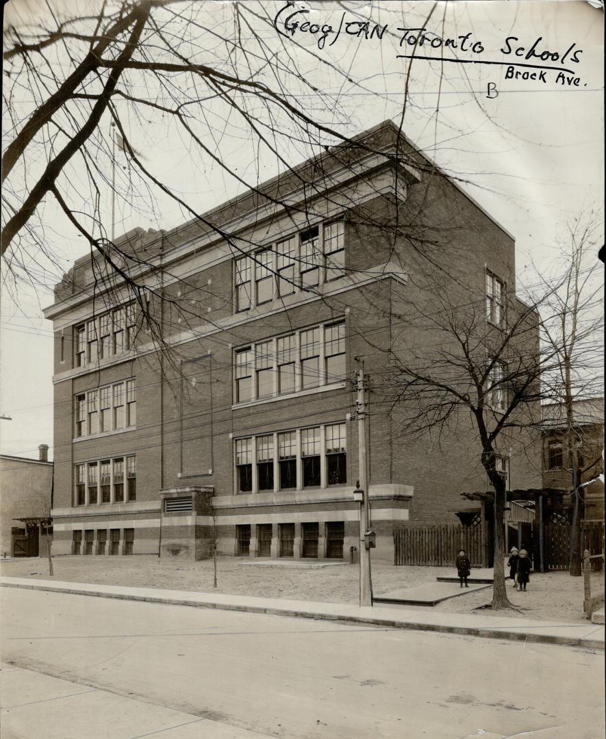 Street view of exterior of three-storey brick building with double-hung windows. Right, three s ...