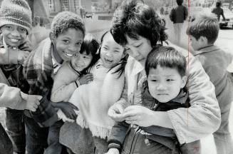 Happy pupils frolic on the grounds of Kensington Community School on College St