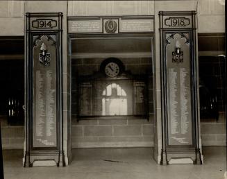  Two, dark wood pillars with dates carved at top. Pillar left reads, 1914; pillar right reads, …