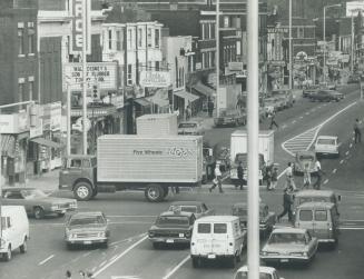 Overhead view of multi-lane, commercial street with business sings, awning and theatre marquee …