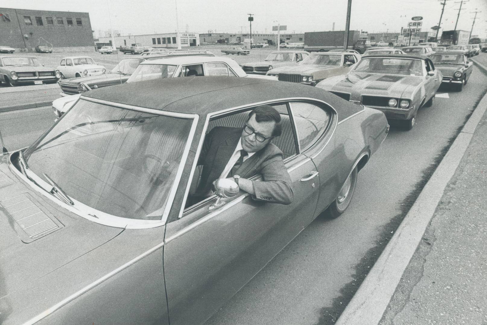 Supermarket executive Dave Luciuk, stalled in the rush-hour traffic on Keele St