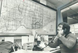 Dispatcher Larry Tyo checks location of Metro trouble spots in storm