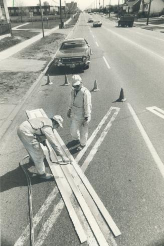 It's good painting weather, and Carl Cambell (left) and Jimmie Bayes can paint 10 of them a day