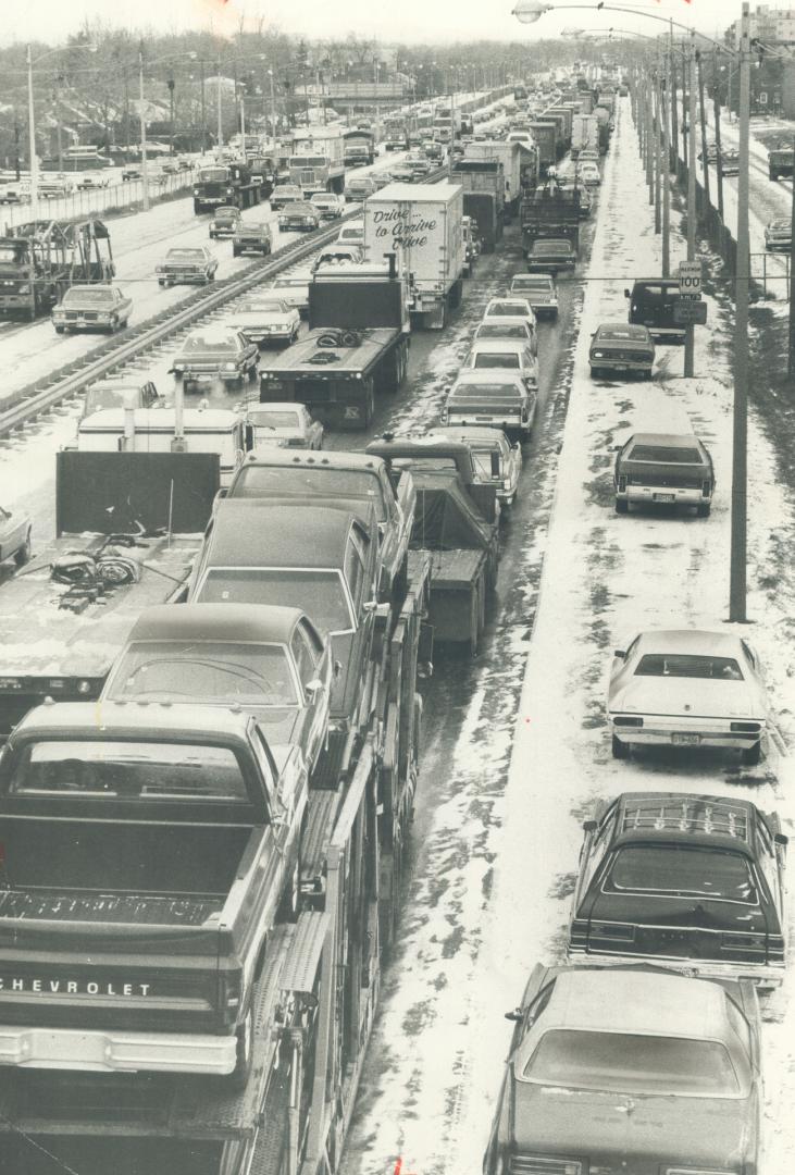 Cars are lined up for miles on the Queen Elizabeth Way this morning as snow squalls turn into glare ice, resulting in dozens of minor fender benders. (...)