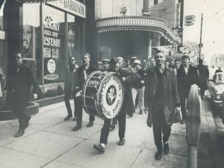 Engineering students, with band, march on bloor