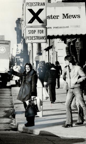 Karen Longlade uses Yonge St. crosswalk. One reader suggests in letter, that pedesrians activate a flasher before entering crosswalk