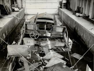 What was left of a T.T.C. launch after an explosion in a boathouse at the foot of John St. Tommy Holmes. V.C., was painfully burned on face and hands