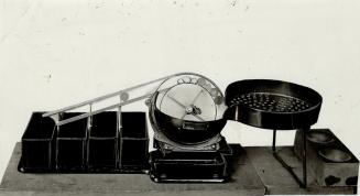 Machine which performs secondary sorting of coins. Boxes hold (1) Large coppers and quarters (2) Large nickels (3) small coppers and (4) dimes