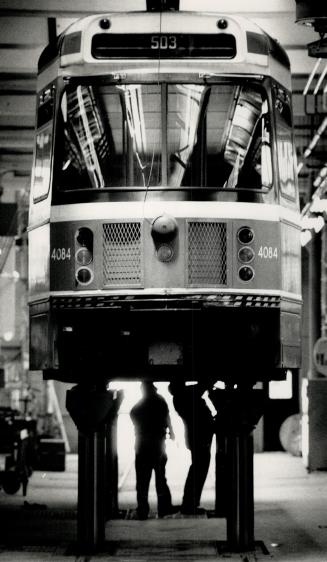 Keep 'Em rolling: When streetcars need a checkup, a good scrubbing or a boost on the huge new hoist, they are wheeled into the Russell carhouse, oneof the TTC's four streetcar barns