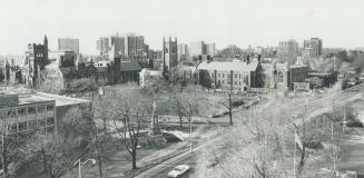 University College, left, and Har House on University of Toronto downtown campus, against backdrop of city high-rises