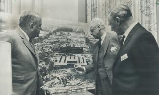 York U. Officials look over photo of progress on $100 million Keele St. Steeles Ave. campus. From left