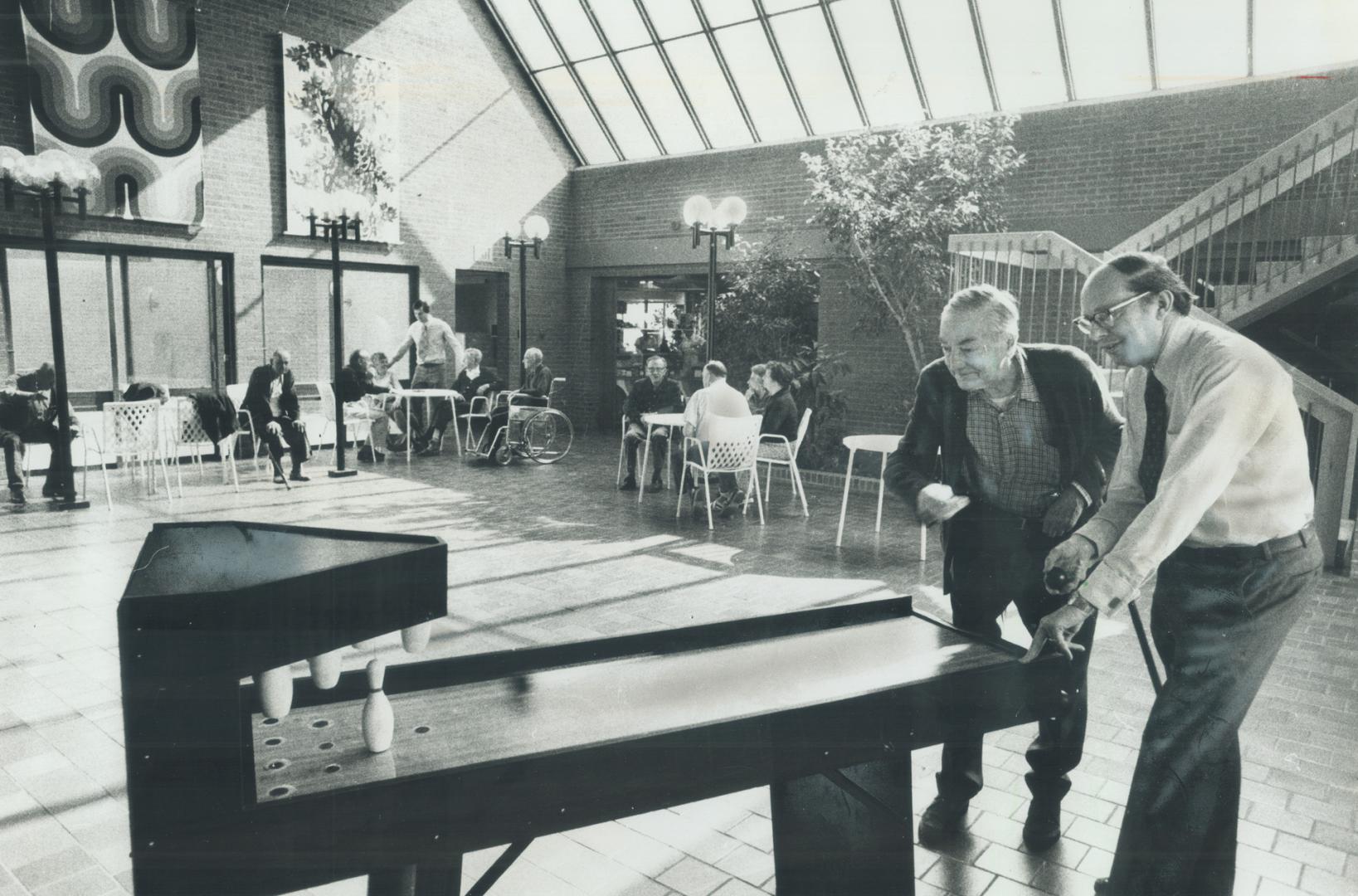 Miniature game of bowls at the metro Toronto Legion Village is enjoyed by Larry Bullock, left, one of the residents, and the designer Nicolaas Ypes. Y(...)