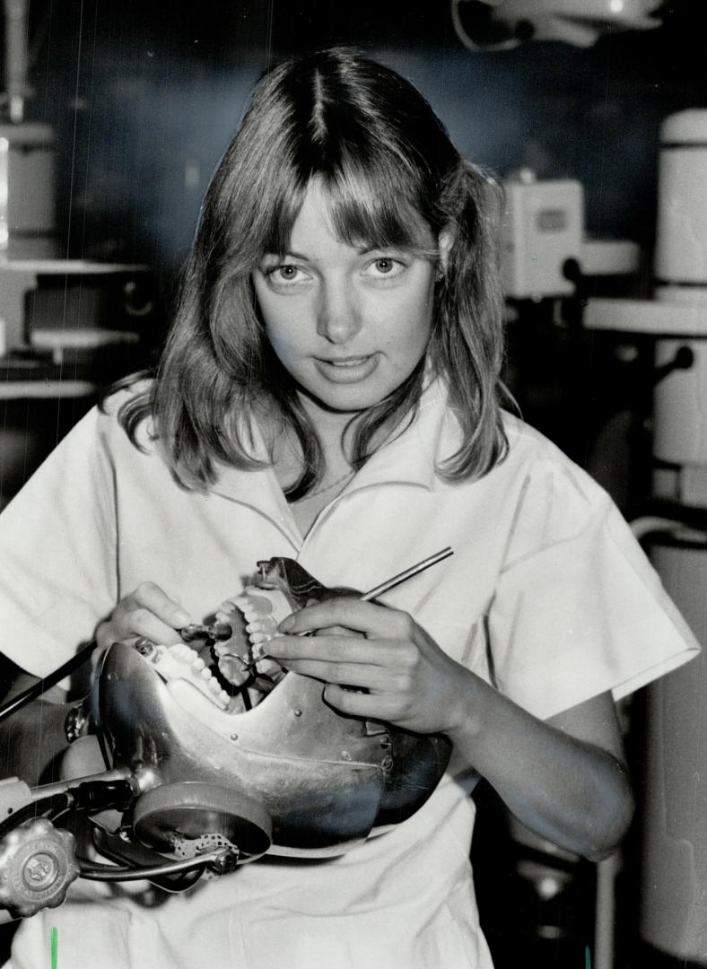 Toothsome task. Second-year Skull-diggery dentistry student Barbara Carruthers works on a phantom head at the University of Toronto's main clinic, which held open house yesterday