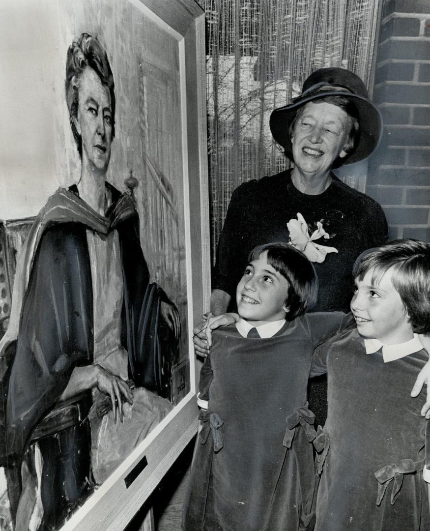 Gift at homecoming. Portrait of Dr. Jessie Macpherson, dean of women at Victoria College until her retirement last year, is admired by Anne and Sally (...)