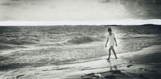 Early morning on beach and shipwrecked Heather Milnes heads out to get rainwater that unusual holiday makers collected in plastic sheets on desert island