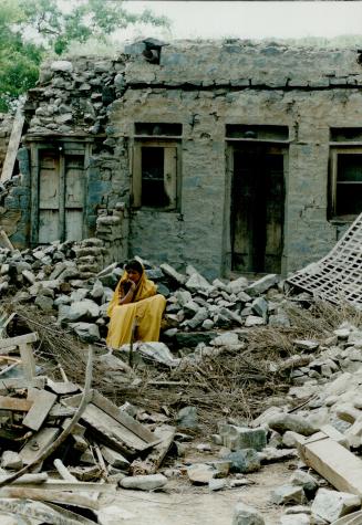 Sister in Law of Anjad Sayed amongst the Rubble of their family home in Kilari