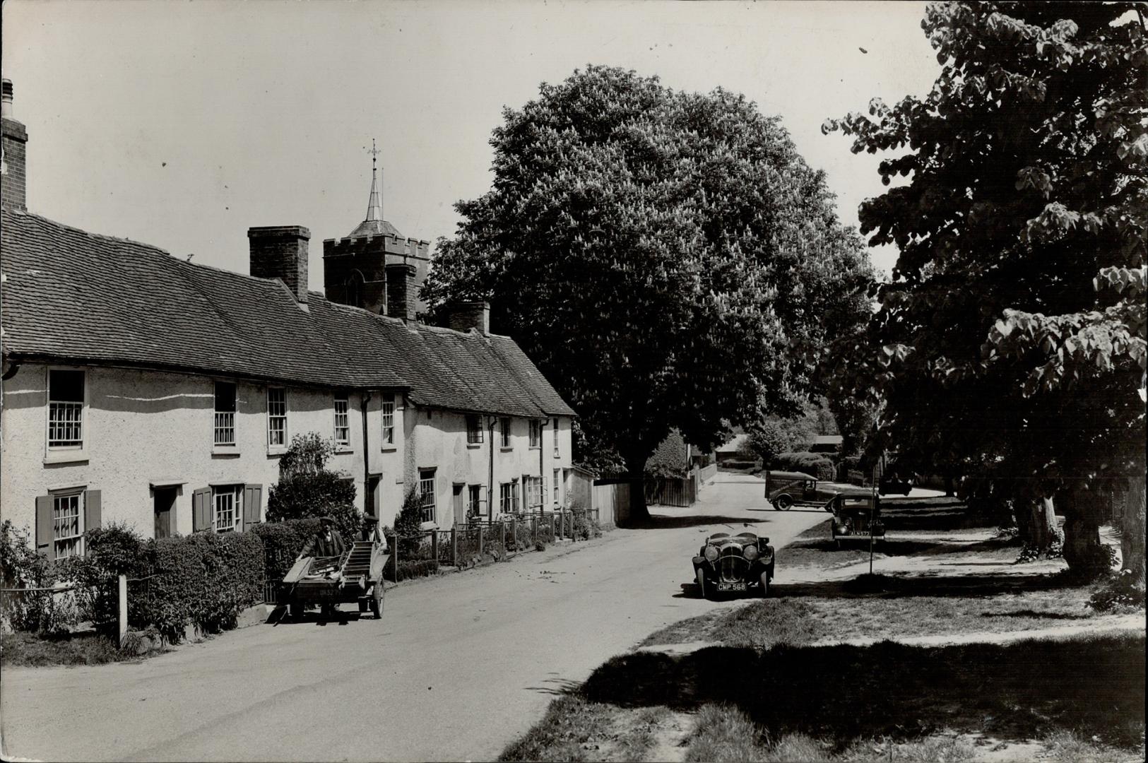 The static charm of peaceful English villages where time seems to stand still in here at its tranquil best on the main street of drowsy West Mill in Herts. [Incomplete]