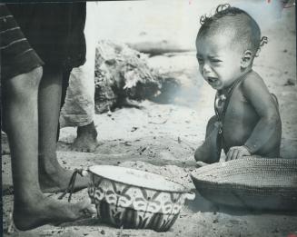 In famine-ridden Africa, a baby cries in a refugees camp in Nigerm where 7,000 Tuareg nomads have fled