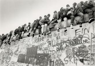 View from the top: East and West Germans alike clambered to get a look at each other's cities from the top of the Berlin Wall near Potzdamer Platz