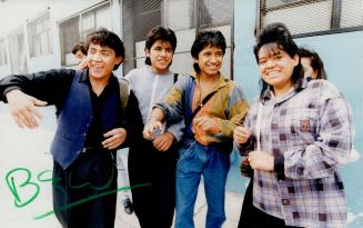 Working class: Juan Carlos, 17, far left, and Dora Luz, 16, far right, are happier in a Mexico City nylon factory than in a maquiladora