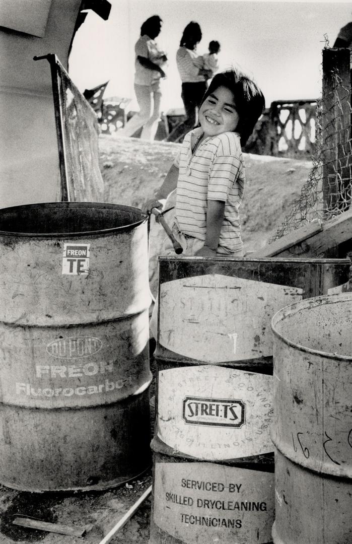 Health risk: water supply for families is stored in drums that held chemical poisions