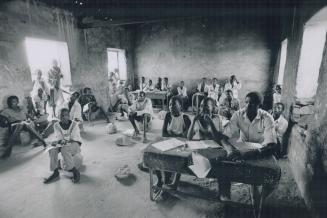 A school in name alone, at Palataka pupils gather firewood, labor on the school's farm, and cook rationed beans and corn over open fires