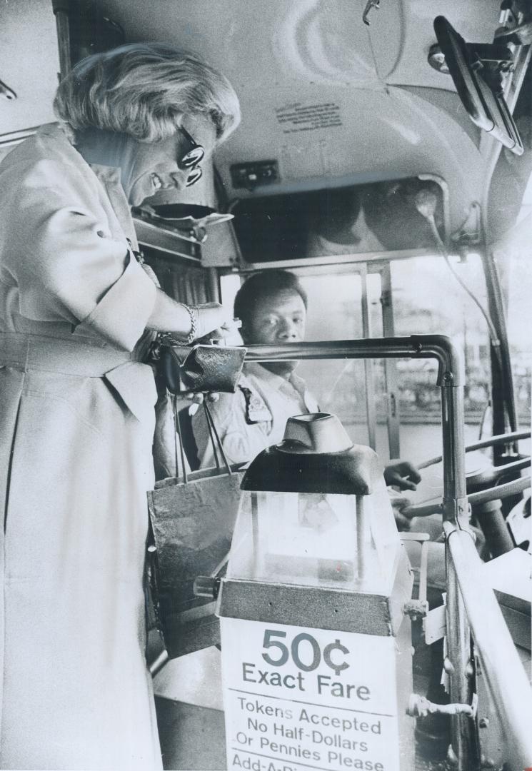 Visiting New York from Pittsburgh, Jean Zehner, 56, opens her wallet to pay the exact fare on a Manhattan bus