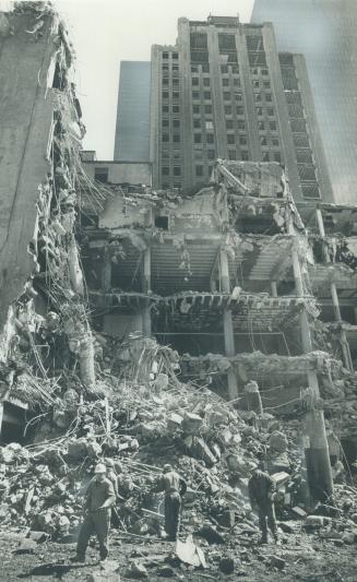 Old star plant is tumbling down, Workers clear some of the rubble after a wrecking ball smashed into the old Toronto Star building at 80 King St. W. T(...)