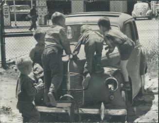 Many persons share boyhood memories of playing on an old abandoned car as these youngsters are, However, with these needy children there's a differenc(...)