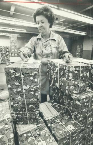 Sorting some of the 150,000 presents in the west-end Star Santa Claus Fund packing depot is Janet Cameron