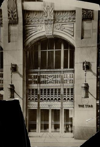 The entrance to The Star is through this splendid door of bronze between columns of granite which the whole facade is built