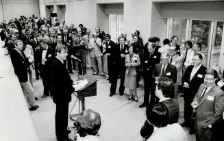 The Star's financial editor, John Bryden, tells a reception at the new Toronto Stock Exchange of plans for expanded business coverage. About 230 executives attended