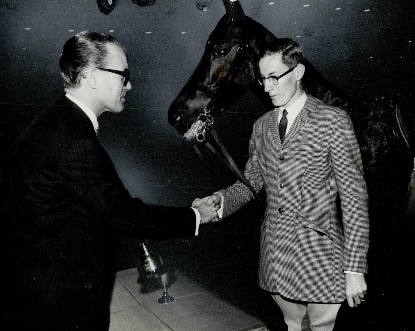 Junior jumping champ Dave Lancaster won Star Trophy, Gordon Kennedy, promotion and public relations manager, congratulates him