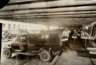 Here on Pearl St., cut under the mailing room, is the loading platform where the fleet of trucks take the editions from the chutes