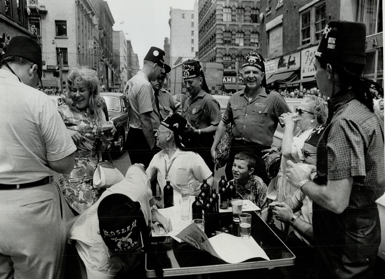 Beer on Yonge St., This table loaded with beer was set up by Shriners right in the middle of Yonge St. Despite the efforts of policeman in the backgro(...)