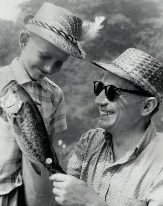 Egils Klavins looks at Fish Father Walter Klavins caught, The High Park Ave