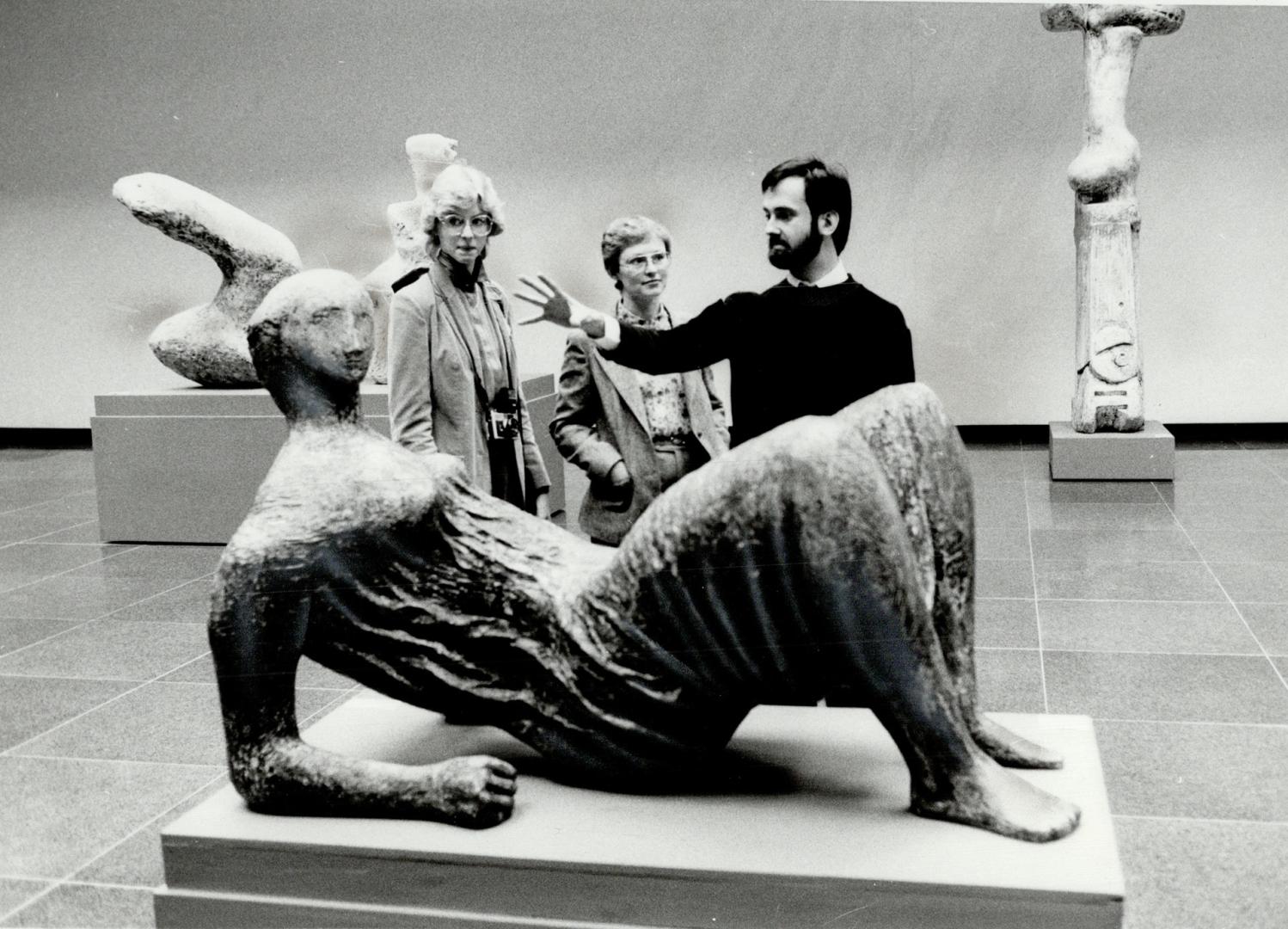 Moore fans: David Wistow, education officer at the Art Gallery of Ontario, takes Laura and her mother past Henry Moore sculpture on Private tour of the AGO