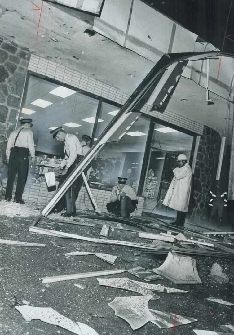 Shattered Glass and twisted metal in front of the Nino D'Aversa Italian Bakery in North York are probed by police after the building was blasted by a (...)