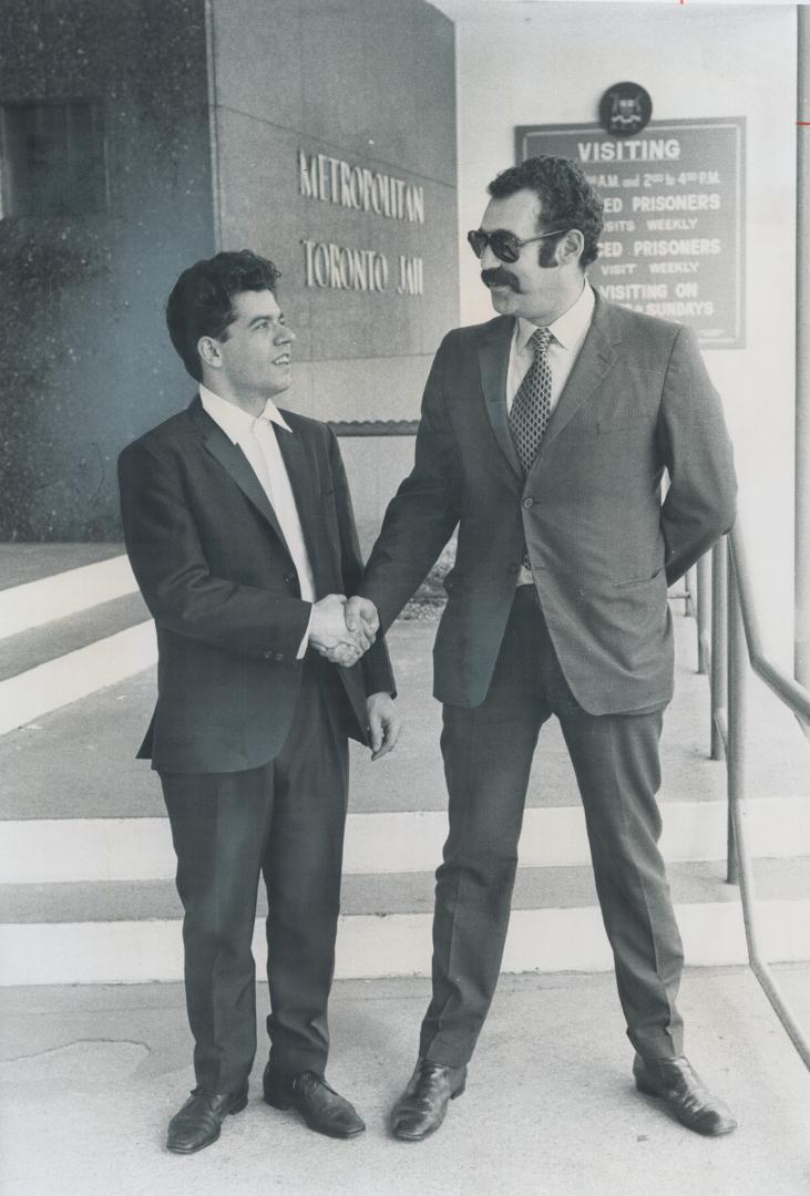 Released from Jail on $200 bond after spending 24 hours behind bars, Greek-born Makis Emanouilidis (left), 23, shakes hands with his lawyer Allan Mintz