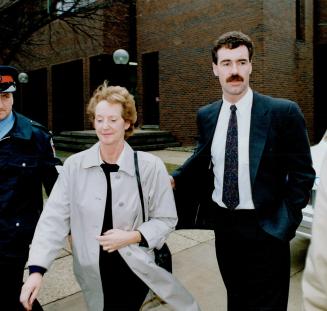 Making bail: Giselle Crispino and husband Alberto Docouto, left, report to police yesterday, as did Catherine Fallon and son Peter