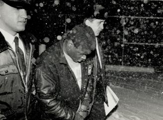 Bomb suspect: Hugh Valentine Ford, 19, is escorted last night by police at Etobicoke's 23 Division station after his arrest