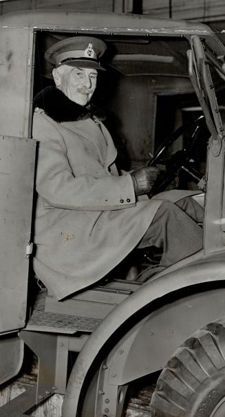 Into the driver's seat of one of the big army trucks being built by General Motors at Oshawa clambered the Earl of Athlone when he inspected the busy factory recently