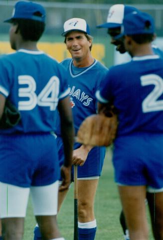 At left, manager Doug Ault imparts some wisdom upon his Florida State league charges, who perform before sparse crowds (below, left) at Grant Field in Dunedin